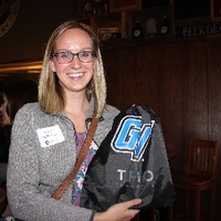 Alumni lady holding up the gv bag she was gifted